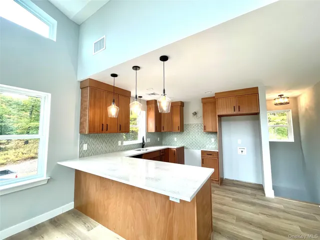 a kitchen with stainless steel appliances granite countertop a sink a stove and a refrigerator