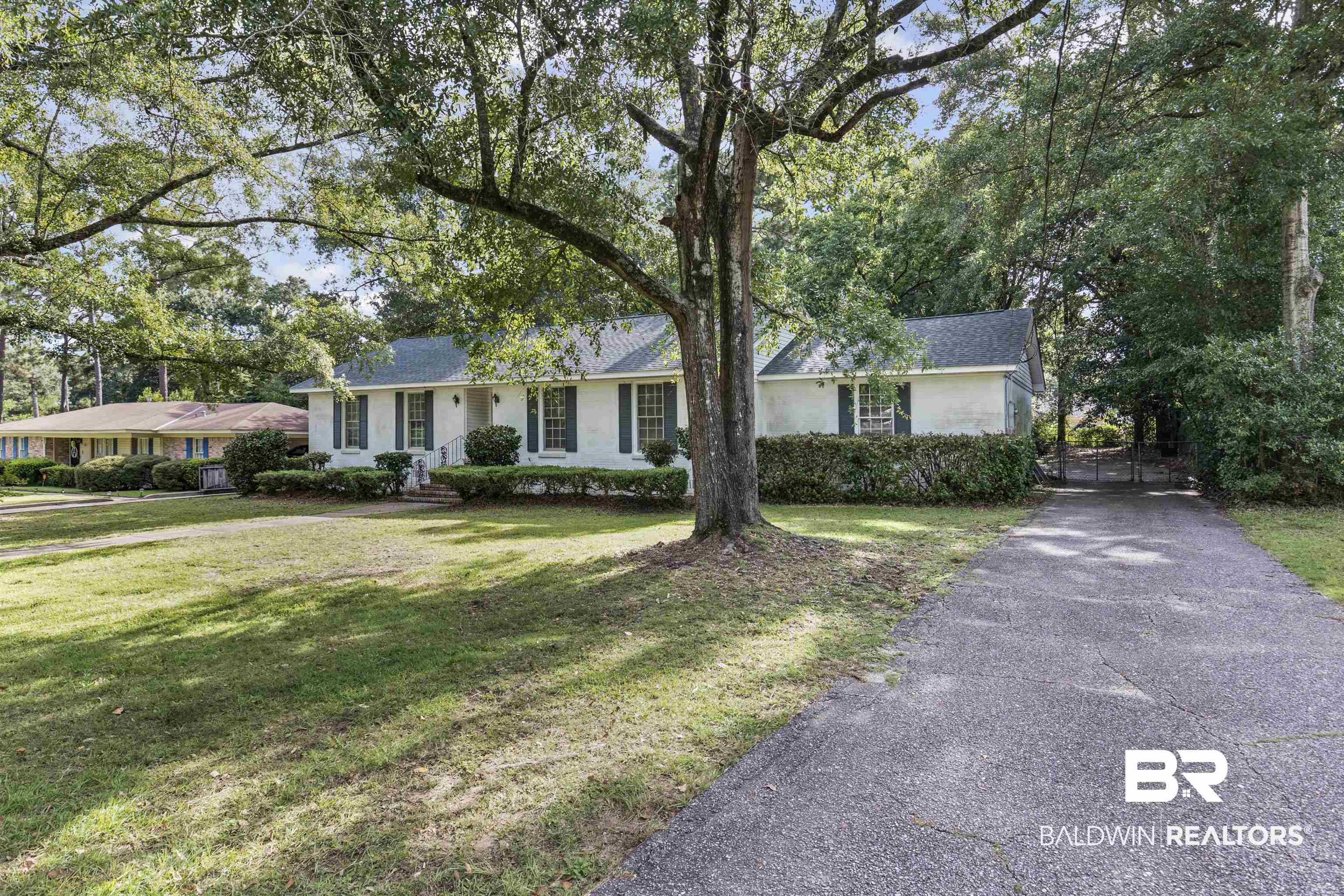 1108 Locarno Street Mobile, AL 36608 - Photo 3 of 24 Ranch-style home featuring a front yard, a gate, asphalt driveway, and stucco siding