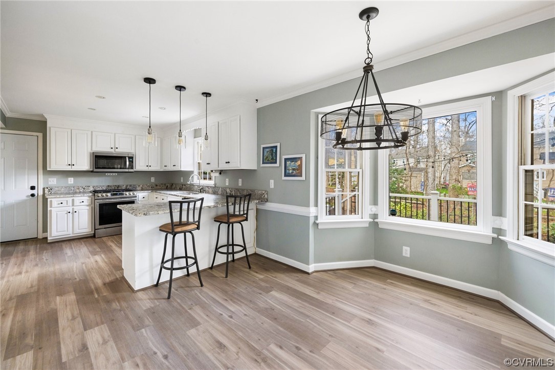 13809 Shadow Ridge Road Midlothian, VA 23112 - Photo 15 of 36 a kitchen with stainless steel appliances a stove a sink dishwasher a refrigerator and white cabinets with wooden floor