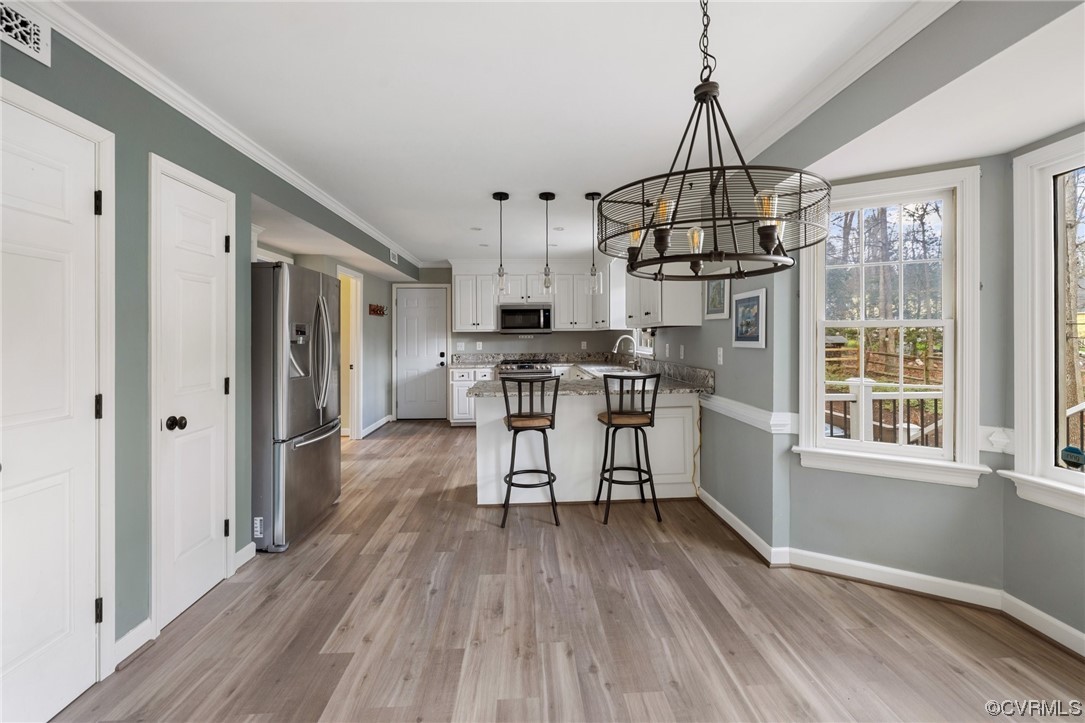13809 Shadow Ridge Road Midlothian, VA 23112 - Photo 20 of 36 a view of a kitchen with stainless steel appliances a window and wooden floor