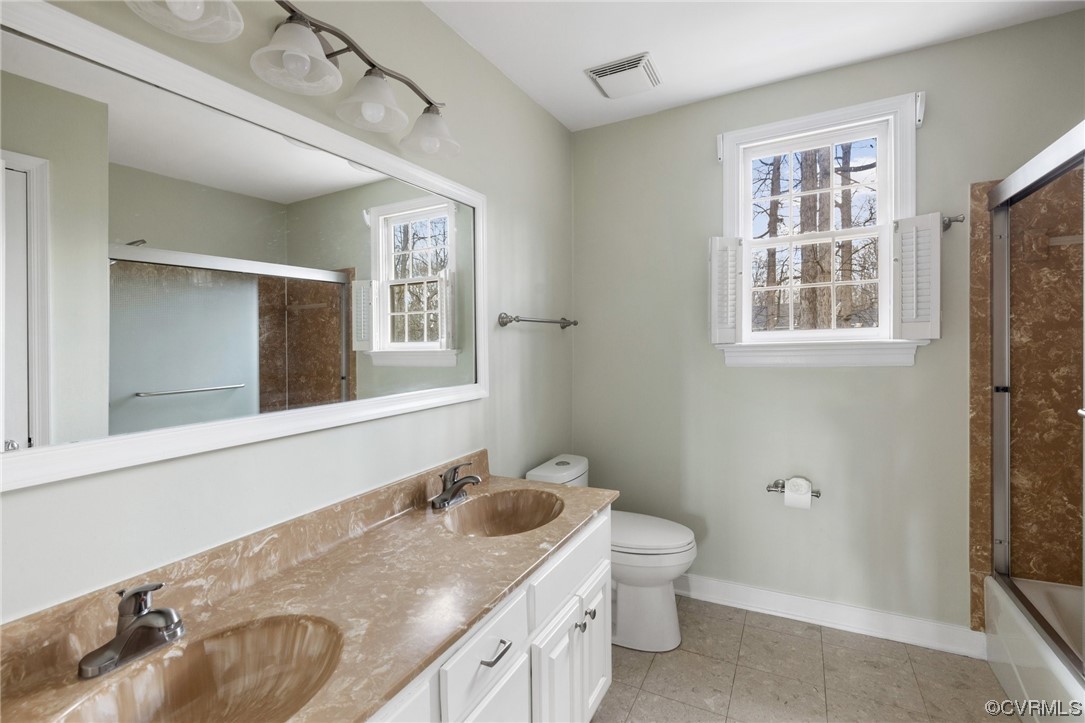 13809 Shadow Ridge Road Midlothian, VA 23112 - Photo 27 of 36 a bathroom with a granite countertop sink toilet and shower