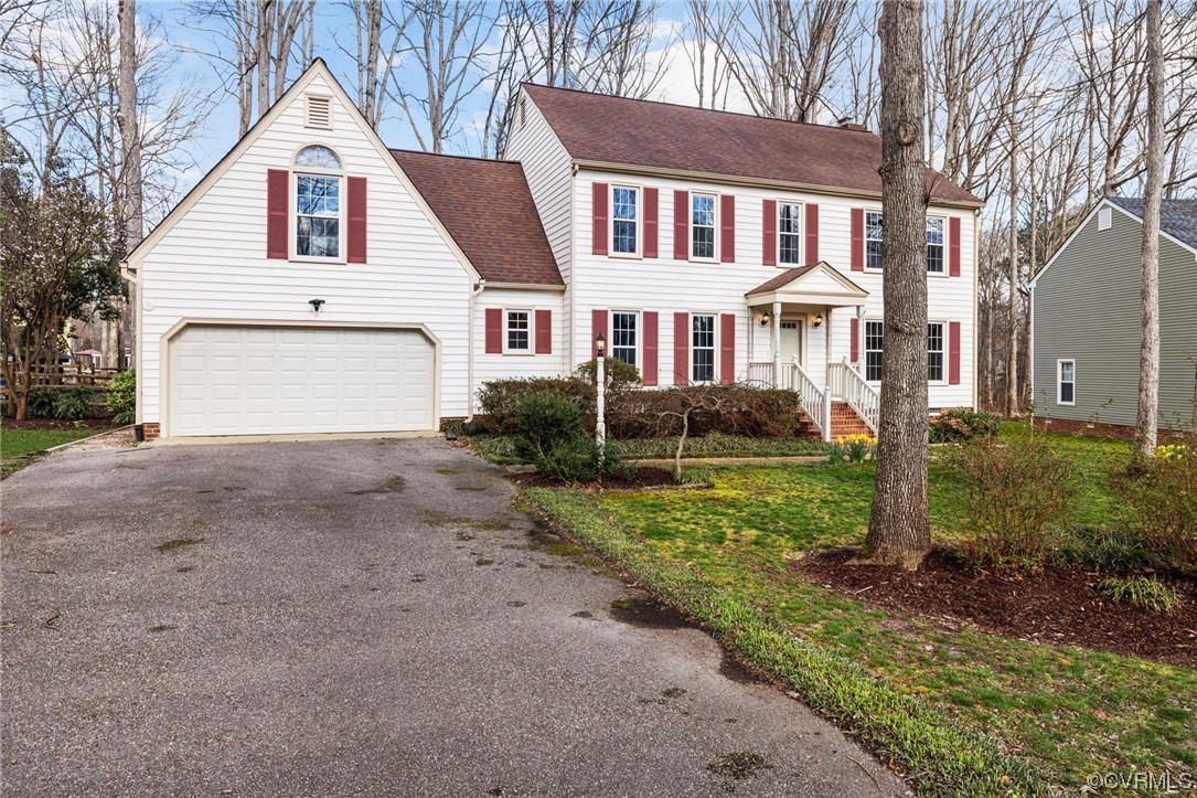 13809 Shadow Ridge Road Midlothian, VA 23112 - Photo 3 of 36 a front view of a house with a yard and garage
