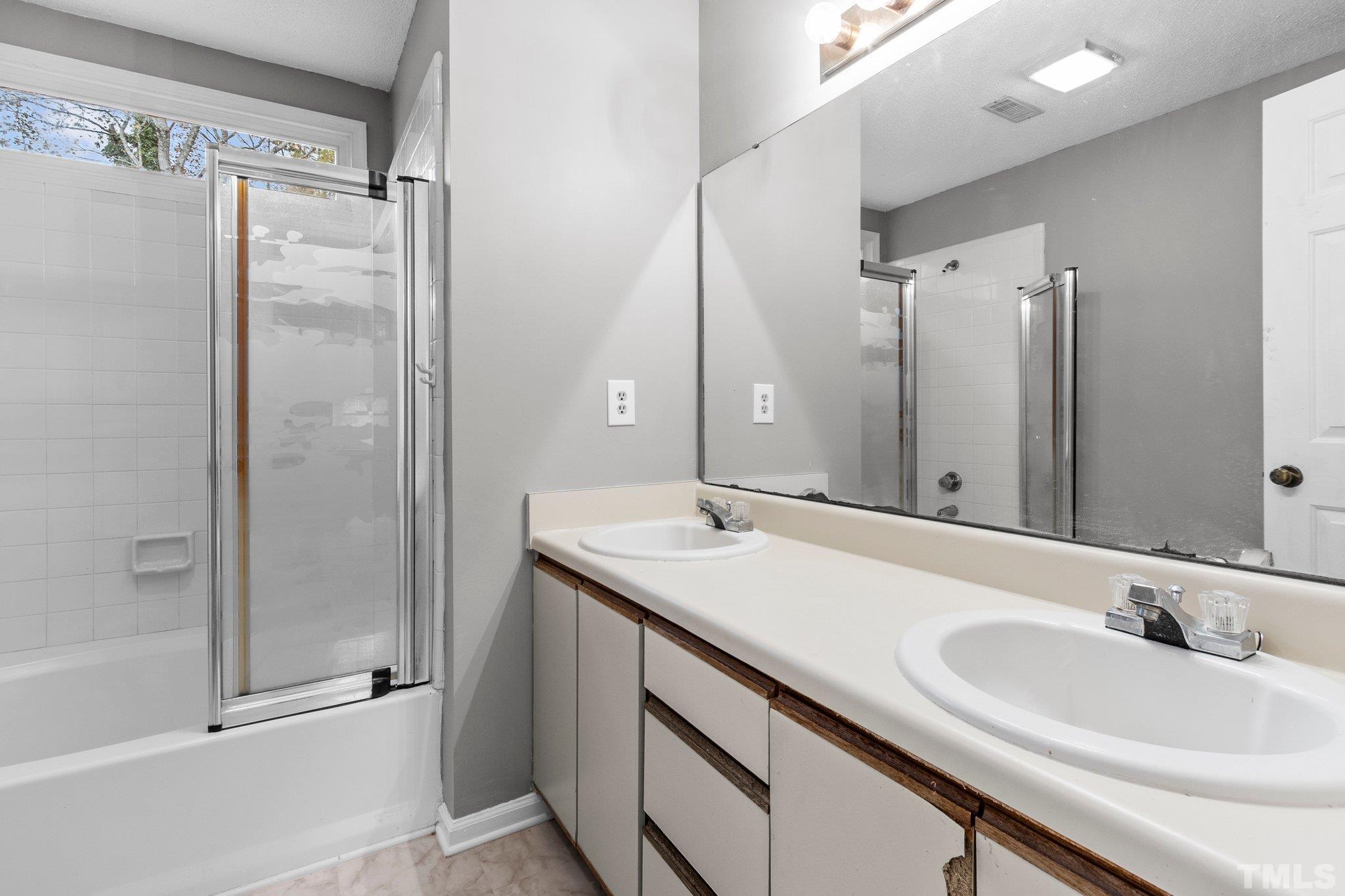 1305 Logan Street Durham, NC 27704 - Photo 12 of 32 a bathroom with a sink and a mirror