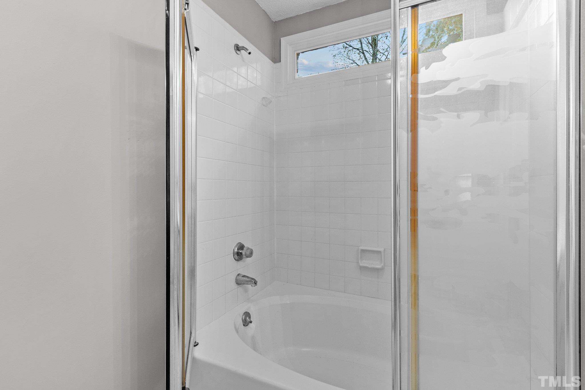 1305 Logan Street Durham, NC 27704 - Photo 13 of 32 a bathroom with a bathtub