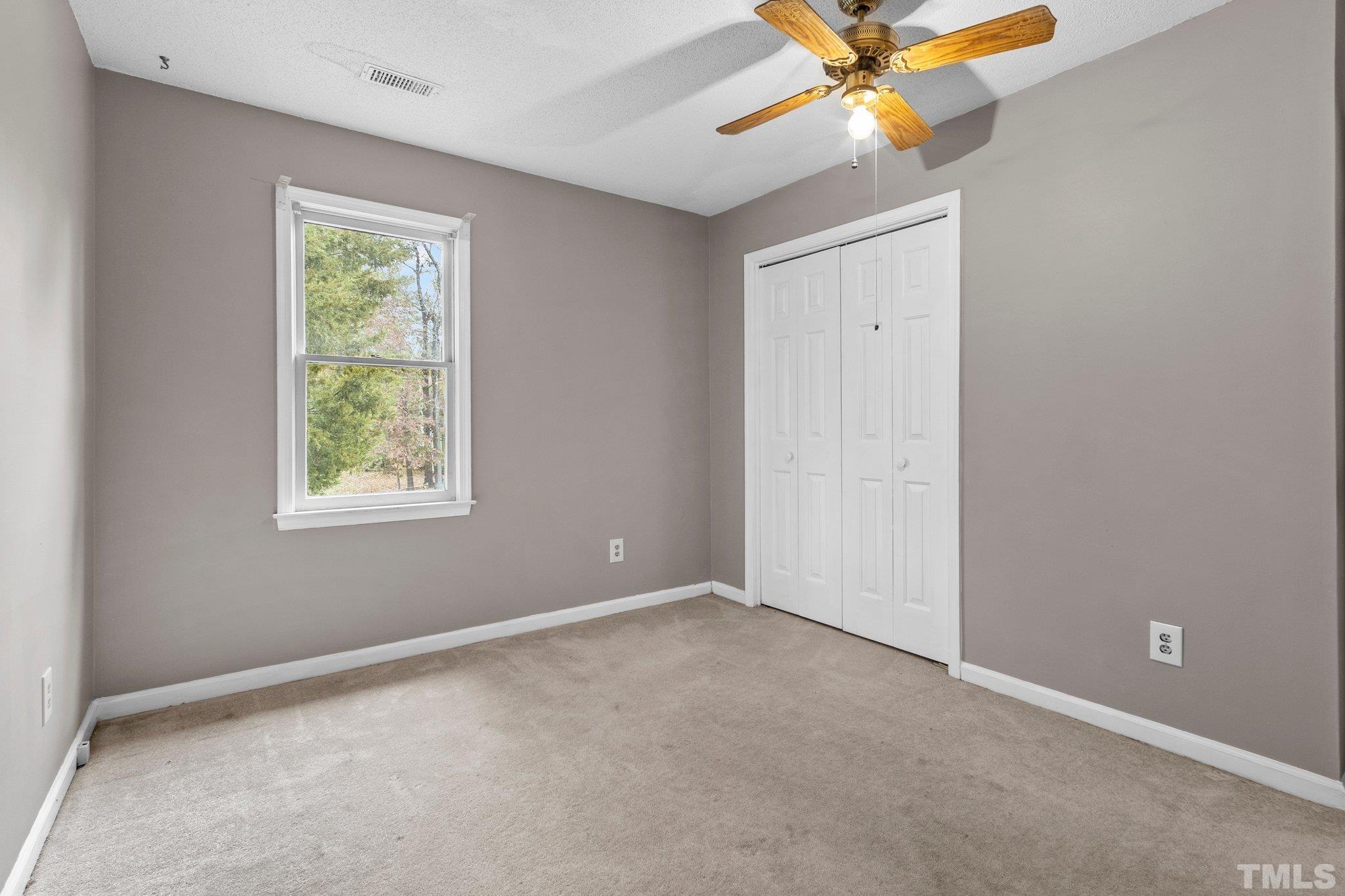 1305 Logan Street Durham, NC 27704 - Photo 14 of 32 an empty room with a window and a fan