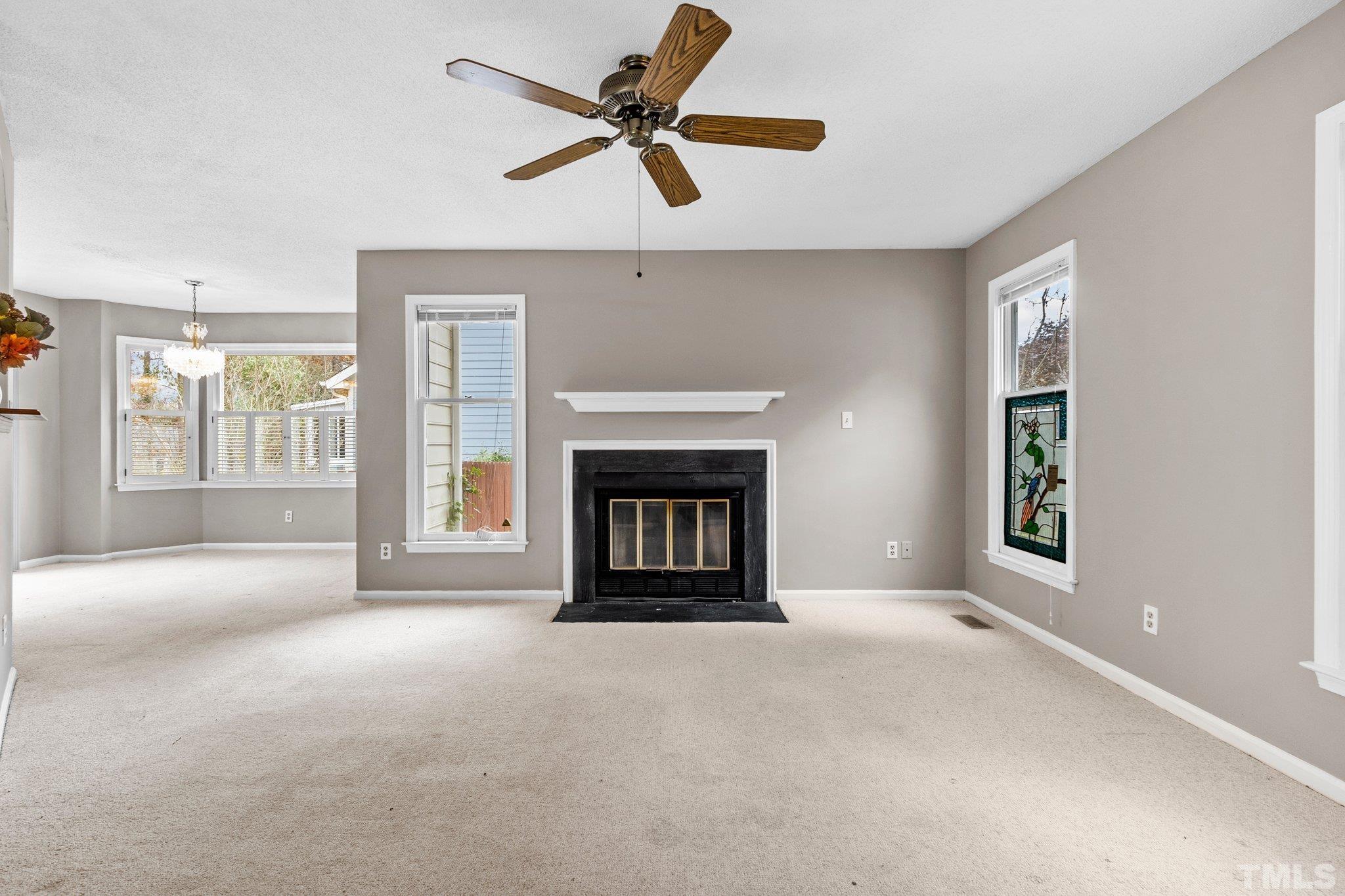 1305 Logan Street Durham, NC 27704 - Photo 3 of 32 a view of an empty room with a fireplace and a window