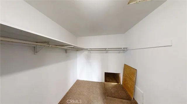 a view of an empty room with a kitchen