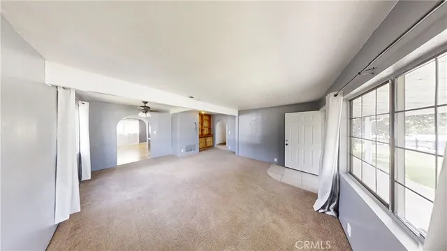 a view of empty room with floor to ceiling window