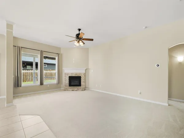a view of an empty room with a fireplace