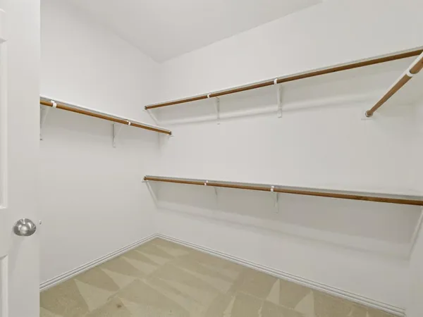a spacious bathroom with a double vanity sink and a mirror