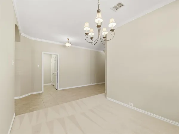 en view of an empty room with a chandelier fan