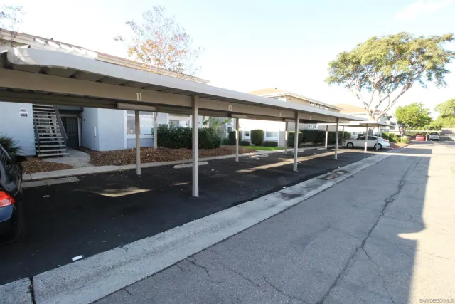 a view of a patio with table and chairs and floor to ceiling window