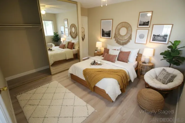 a bedroom with bed and a mirror