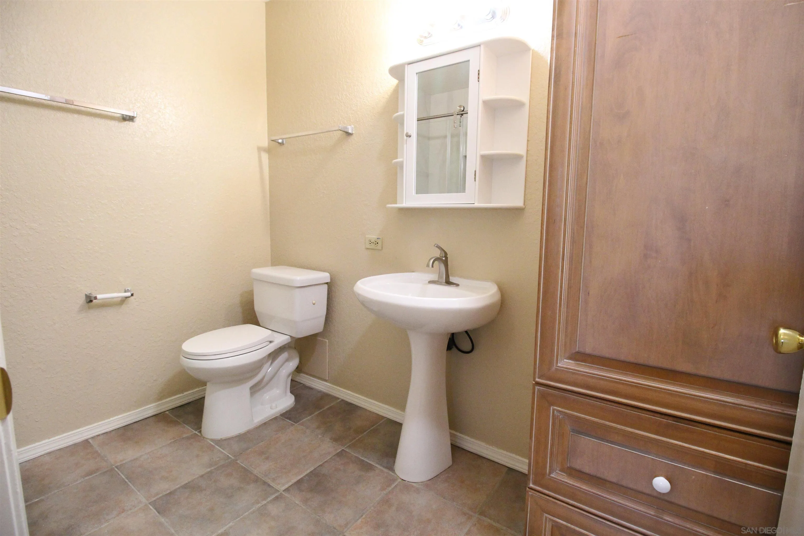 11183 Kelowna Road, Unit 36 San Diego, CA 92126 - Photo 7 of 19 a bathroom with a sink toilet and a mirror