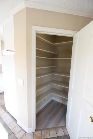 a view of walk in closet with empty racks