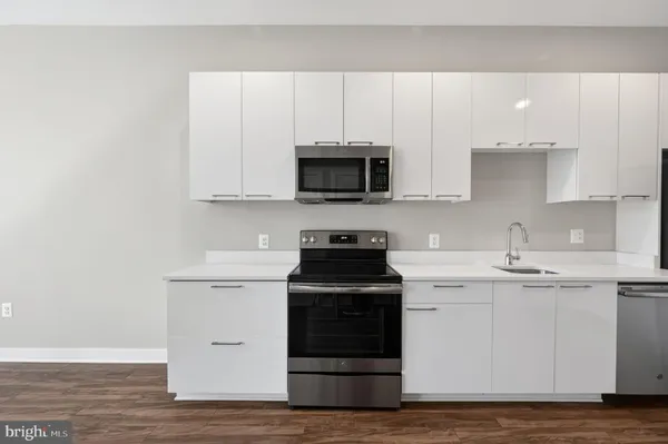 a kitchen with a sink and a microwave