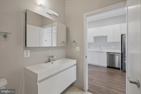 a kitchen with a sink cabinets and stainless steel appliances