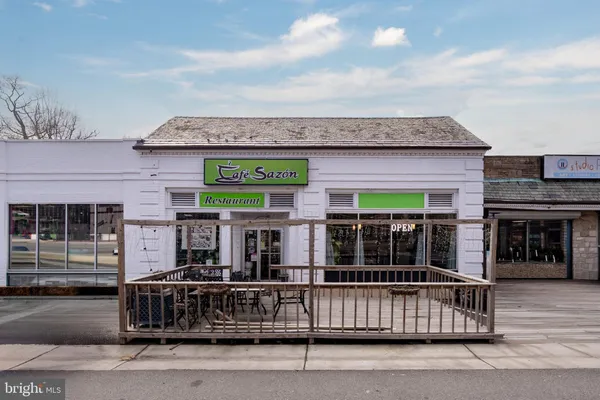 a table and chairs on the side of street