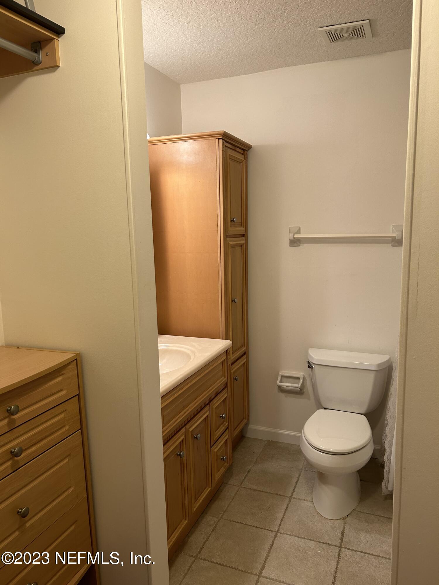 3801 Crown Point Road, Unit 1021 Jacksonville, FL 32257 - Photo 5 of 8 a bathroom with a toilet and a shower