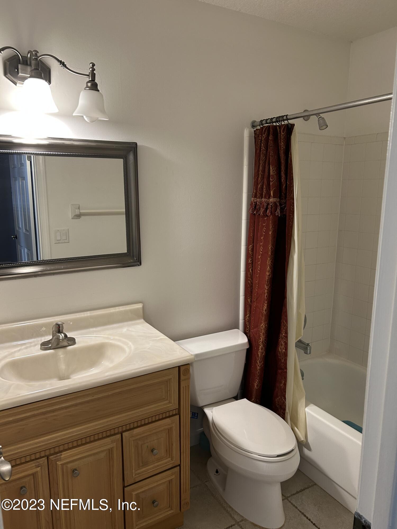 3801 Crown Point Road, Unit 1021 Jacksonville, FL 32257 - Photo 7 of 8 a bathroom with a sink a toilet and shower