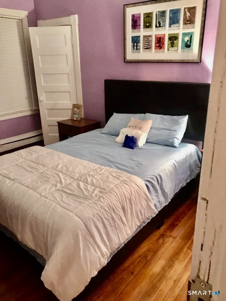150 Whitney Street Hartford, CT 06105 - Photo 14 of 39 a bed sitting in a bedroom next to a window