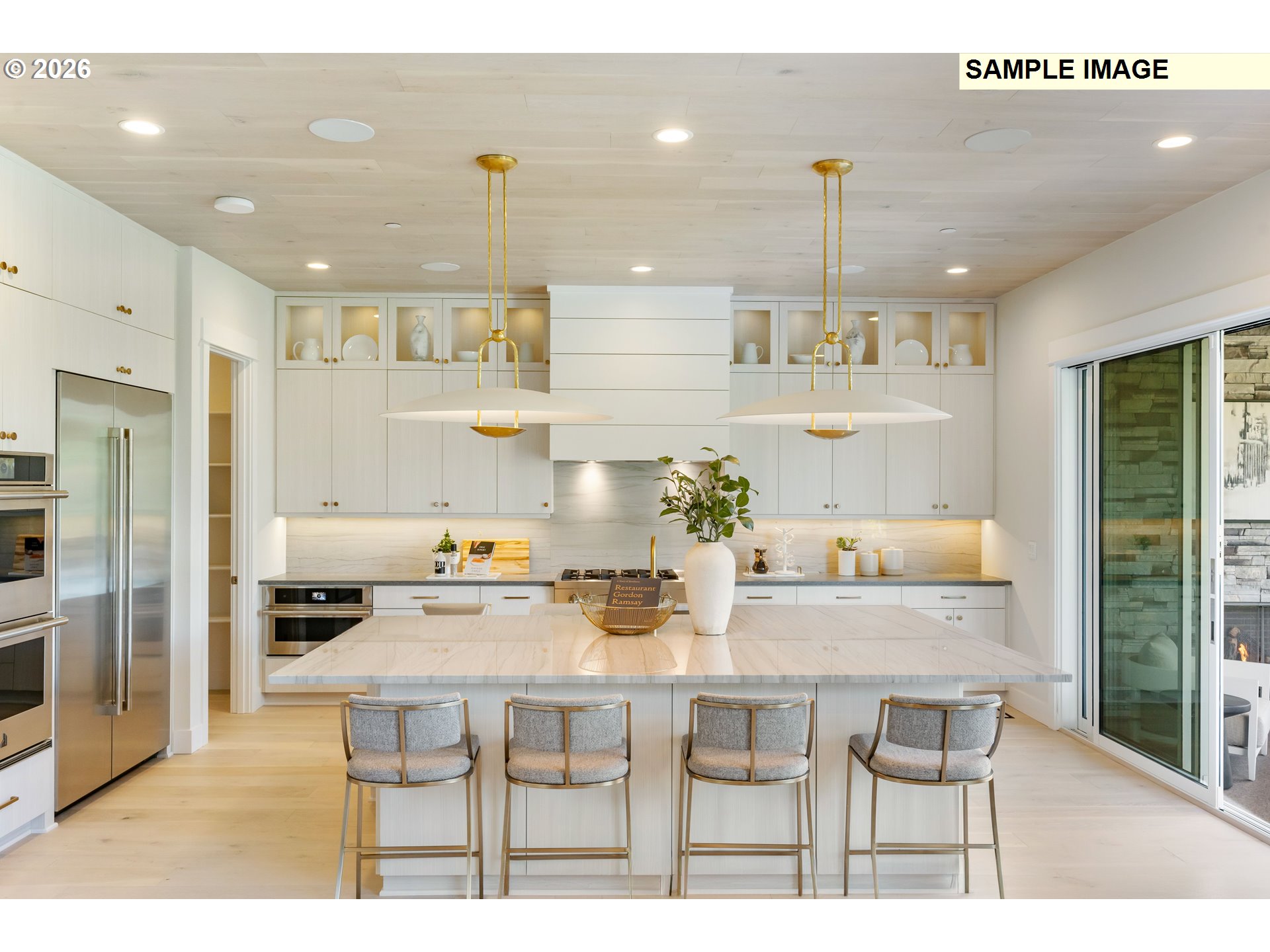 1509 South Creekview Place, Unit L6 Ridgefield, WA 98642 - Photo 7 of 44 a kitchen with stainless steel appliances kitchen island granite countertop a dining table chairs and white cabinets