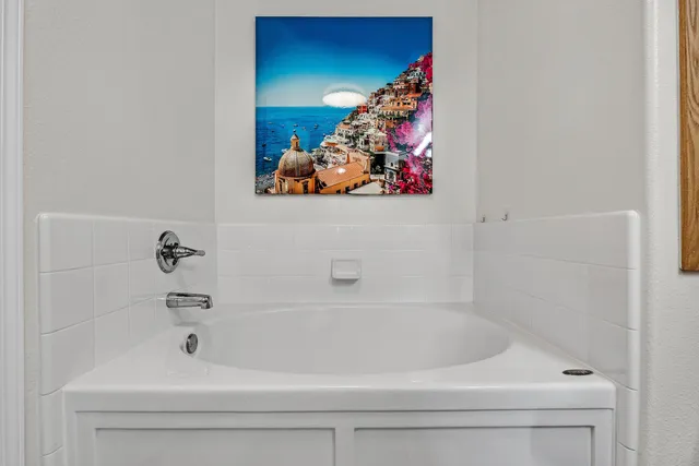 a bathroom with a bathtub and a shower