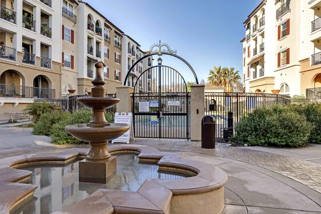 a view of a white house with large windows and yard