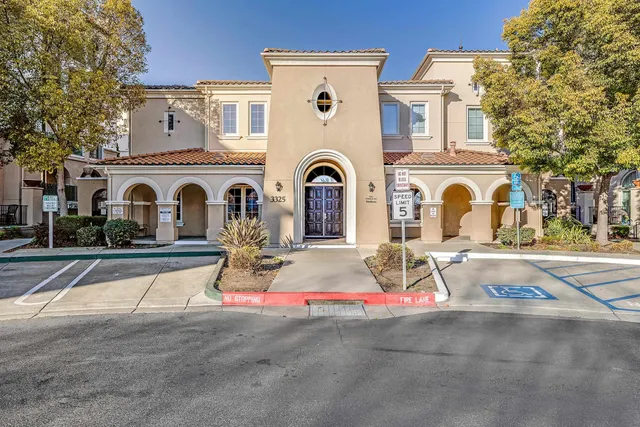 a view of a livingroom with furniture chandelier and fireplace