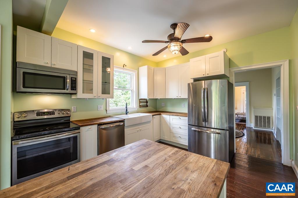 727 Tilman Road Charlottesville, VA 22901 - Photo 12 of 41 a kitchen with granite countertop a refrigerator a stove top oven a sink and dishwasher