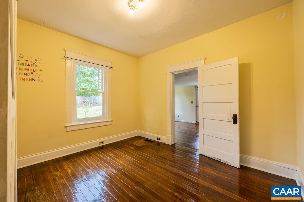 727 Tilman Road Charlottesville, VA 22901 - Photo 15 of 41 an empty room with wooden floor and windows