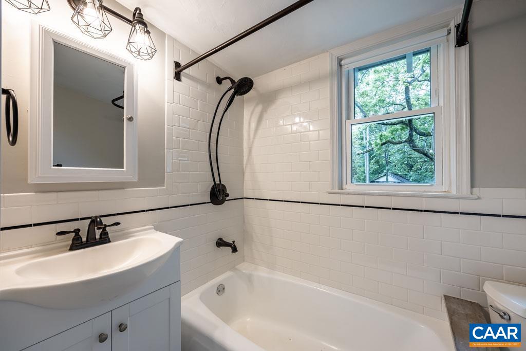 727 Tilman Road Charlottesville, VA 22901 - Photo 17 of 41 a bathroom with a sink a mirror and a bathtub