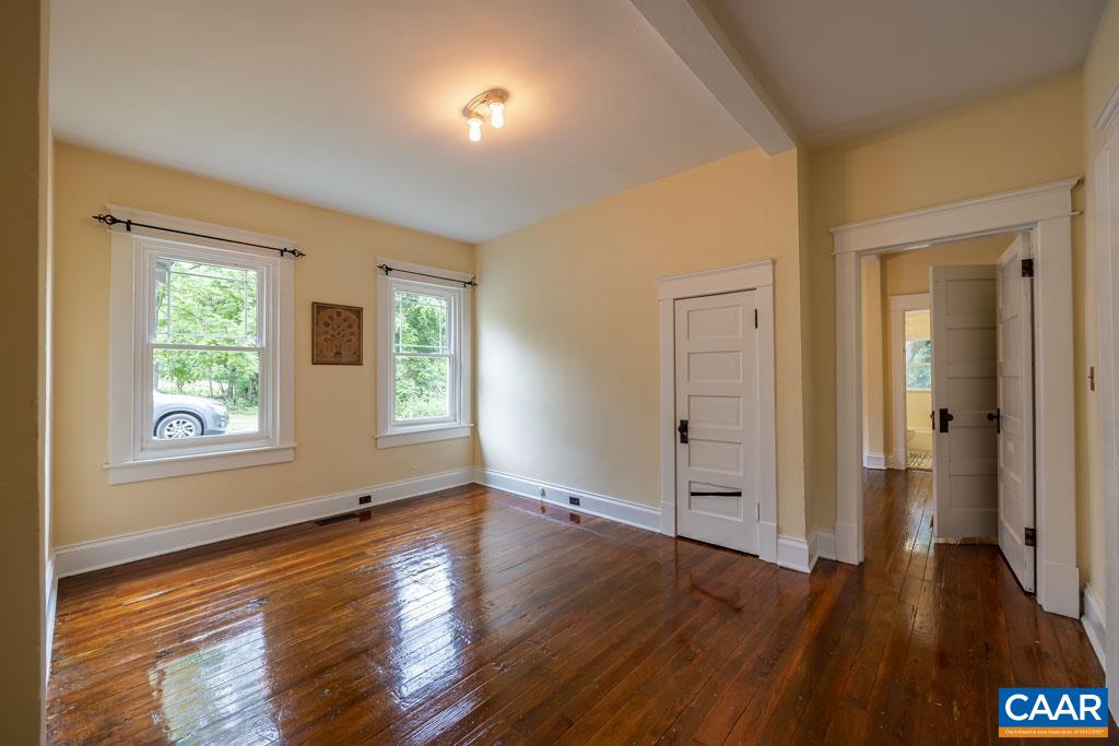 727 Tilman Road Charlottesville, VA 22901 - Photo 19 of 41 an empty room with wooden floor and windows