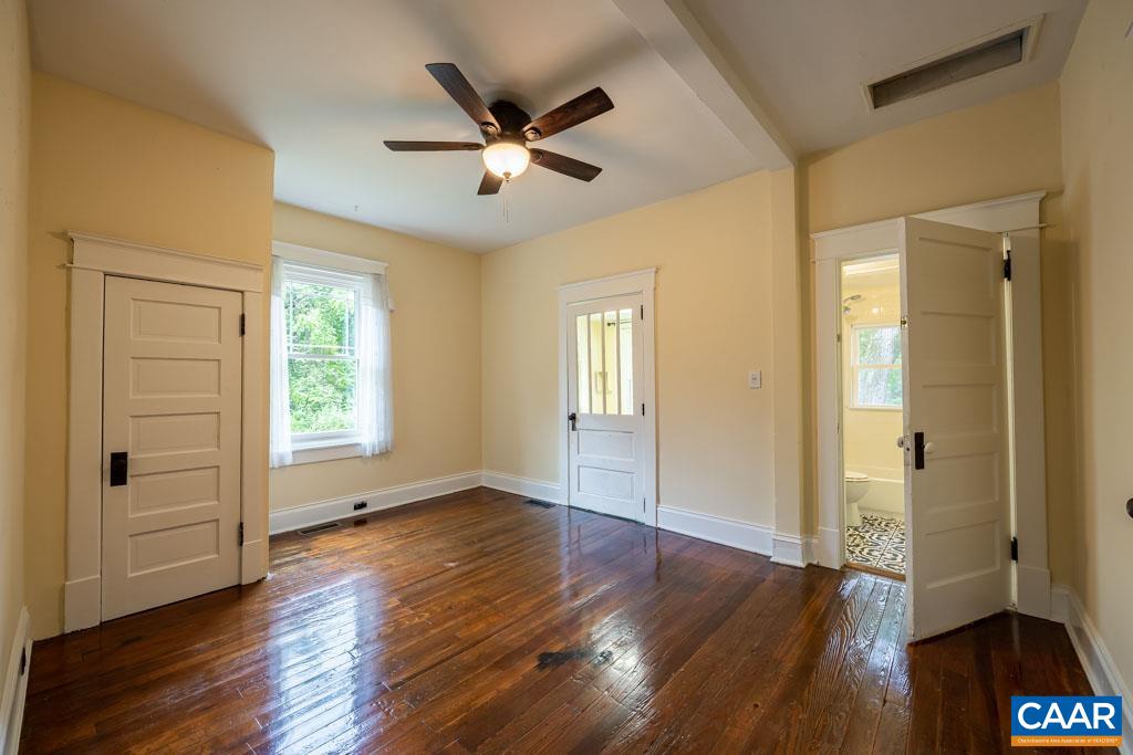 727 Tilman Road Charlottesville, VA 22901 - Photo 21 of 41 a view of an empty room with wooden floor and a window