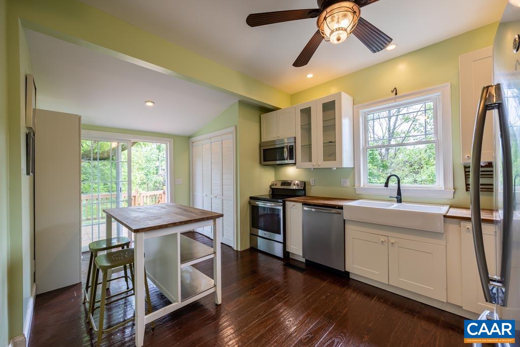 727 Tilman Road Charlottesville, VA 22901 - Photo 9 of 41 a kitchen with a table chairs stove and microwave
