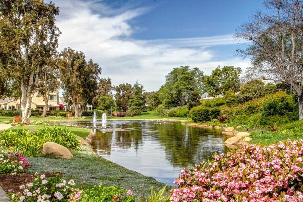 7013 Lavender Way Carlsbad, CA 92011 - Photo 34 of 51 a view of a lake with a house in the background