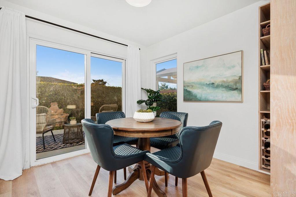 7013 Lavender Way Carlsbad, CA 92011 - Photo 7 of 51 a view of a dining room with furniture window and wooden floor