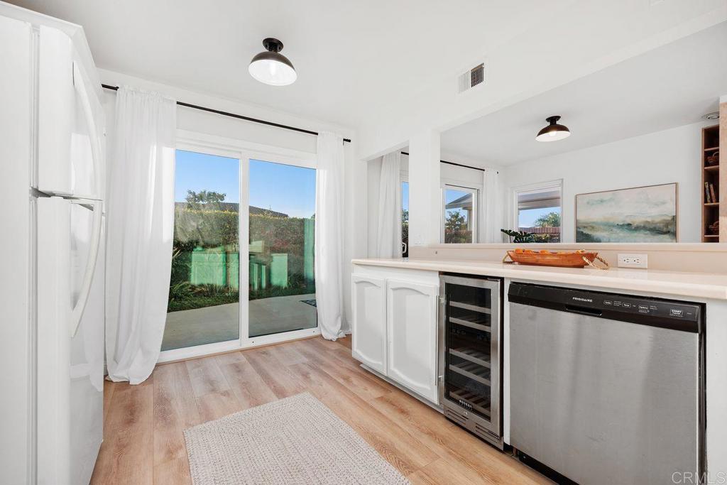 7013 Lavender Way Carlsbad, CA 92011 - Photo 10 of 51 a kitchen with stainless steel appliances a sink cabinets and wooden floor