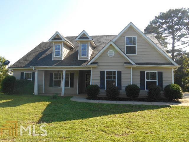 726 Heads Ferry Road Cornelia, GA 30531 - Photo 1 of 1 a front view of a house with a garden