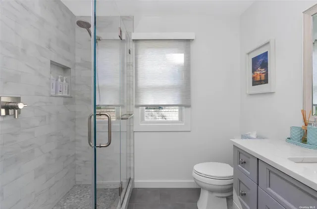 a bathroom with a shower toilet and sink