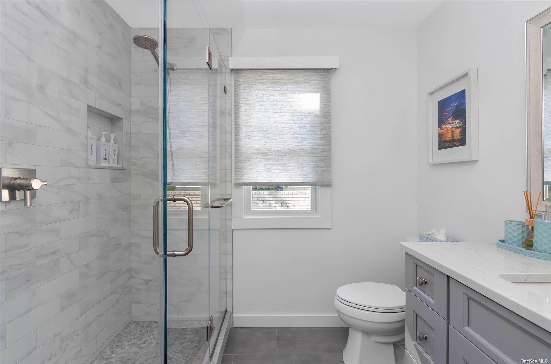 155 Bridge Street Greenport, NY 11944 - Photo 11 of 30 a bathroom with a shower toilet and sink