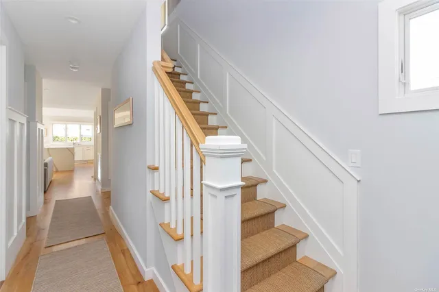 a view of entryway and hall with wooden floor