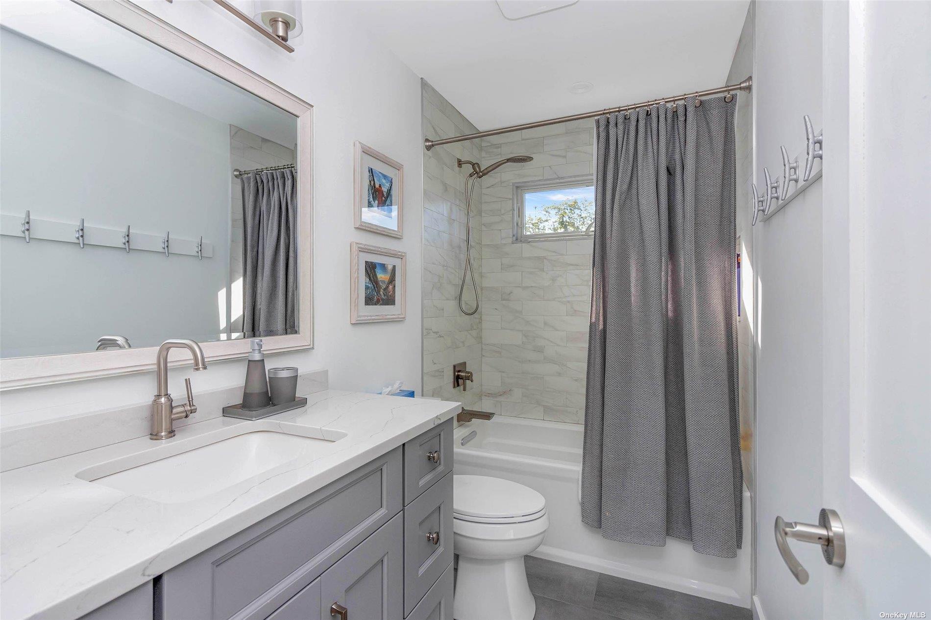 155 Bridge Street Greenport, NY 11944 - Photo 16 of 30 a bathroom with a sink a toilet and shower