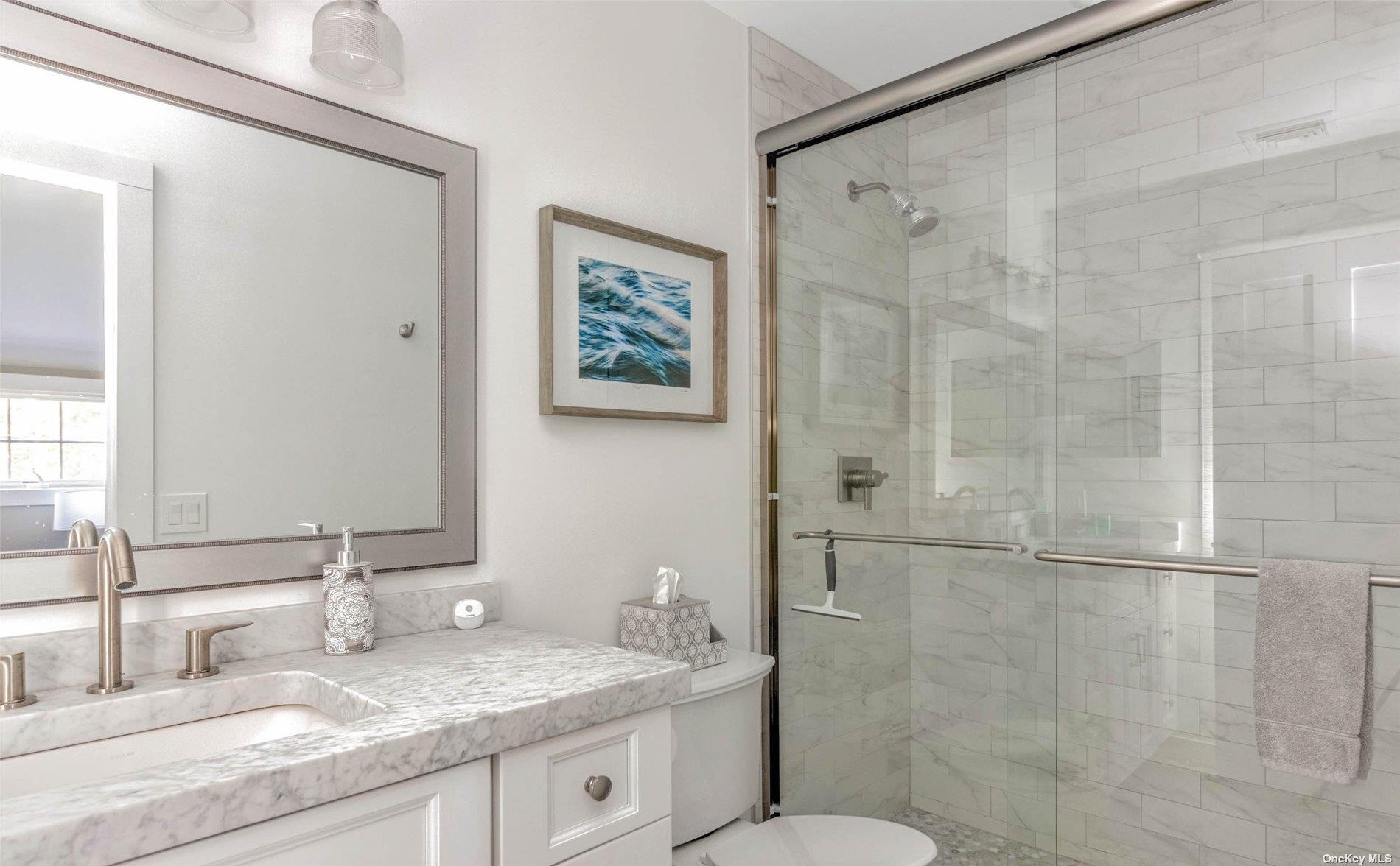155 Bridge Street Greenport, NY 11944 - Photo 20 of 30 a bathroom with a granite countertop sink toilet and shower