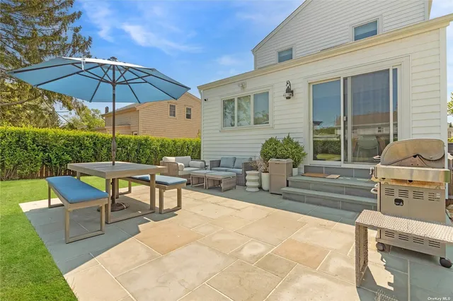 a view of a house with backyard sitting area and garden