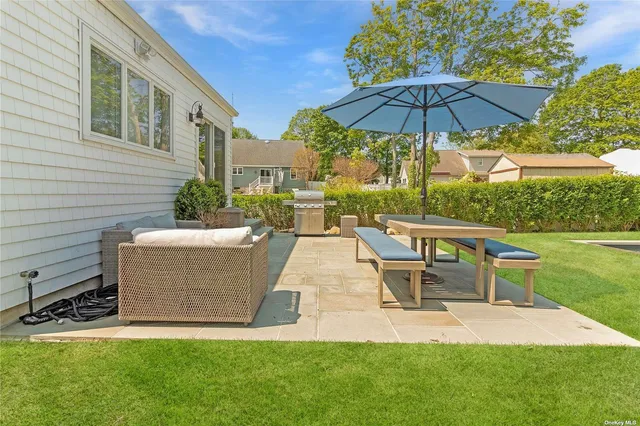 a view of a house with a yard and sitting area