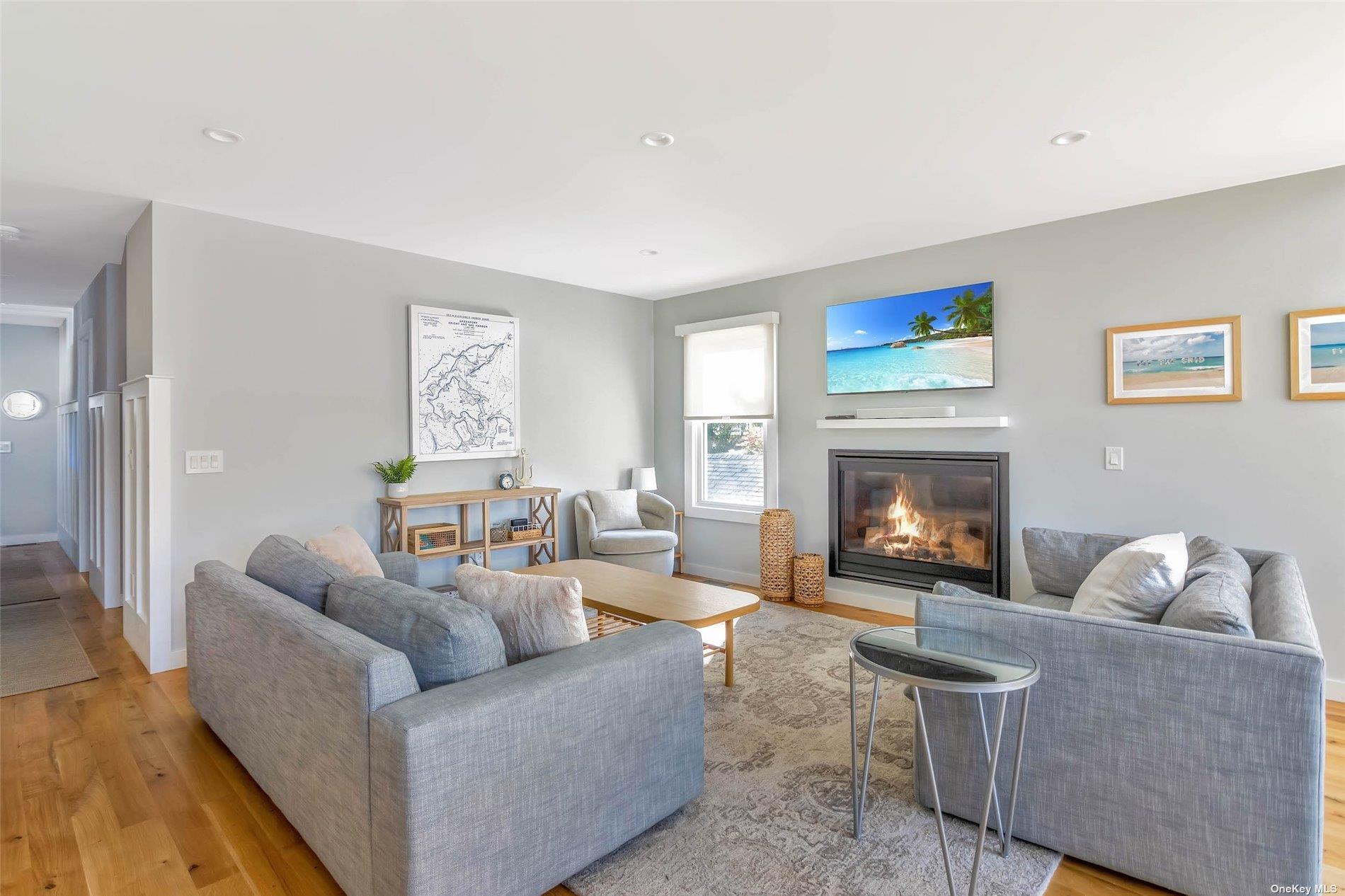 155 Bridge Street Greenport, NY 11944 - Photo 10 of 30 a living room with furniture and a fireplace