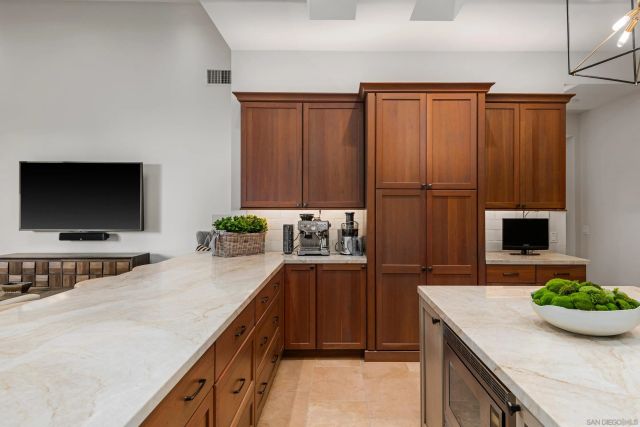 a patio with a table and chairs and potted plants