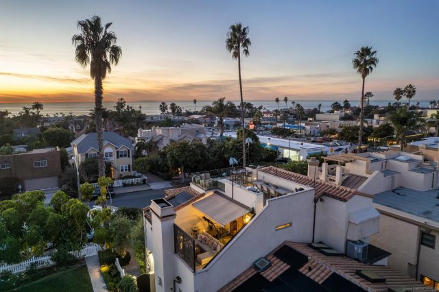 a kitchen with stainless steel appliances a dining table chairs refrigerator and sink