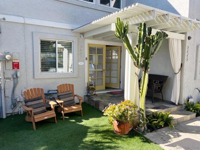 an aerial view of a house with a garden and lake view